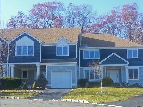 blue house with roof repair complete