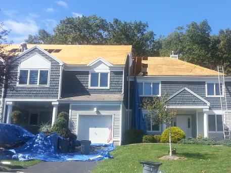 blue house with rood repair in progress